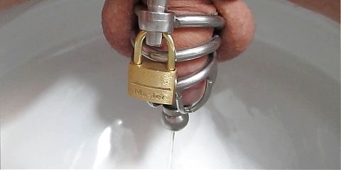Old Clip from 2017: Pissing through the Plug of Chastity Cage
